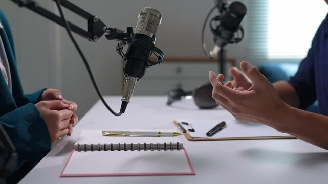 Radio host interviewing guest in a podcast studio