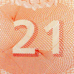 Close-up of intricate orange number 21 design on white background.