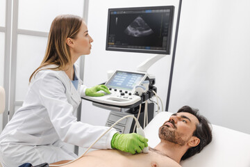 Heart ultrasound exam for male patient with ultrasound specialist while medical exam. Heart health...
