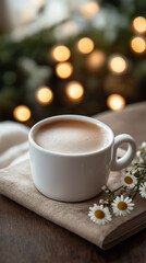 A white cup of coffee stands on a wooden table against the background of bokeh, lights, a beige book and a camomile lying close, wonderful ambient light, sharpfocus, high-quality