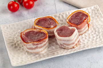 Raw pork tenferloin with bacon
