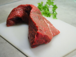 Whole Boneless lamb steak meat with spices isolated on white Chopped beef, slices, abolition of vegetarianism, semi-finished meat products, no soy meat