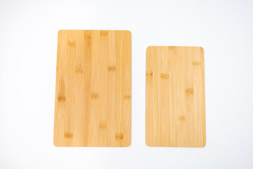 Wooden board on linen napkin on marble kitchen table withgreen leaf, flatlay