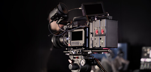 Film or video production setup with high end professional cinema cameras lighting camera rig and crew members working on set. Behind the scenes or BTS video shoot in a studio for cinematic visuals.