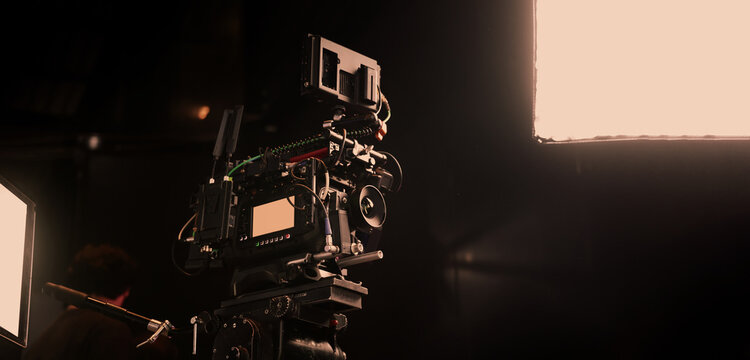 Film or video production setup with high end professional cinema cameras lighting camera rig and crew members working on set. Behind the scenes or BTS video shoot in a studio for cinematic visuals.