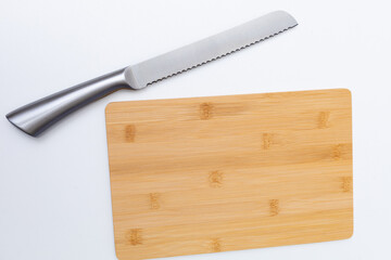 A knife stuck in a cutting board isolated on the white background.
