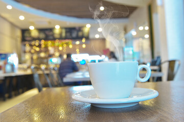 white cup of coffee on table
