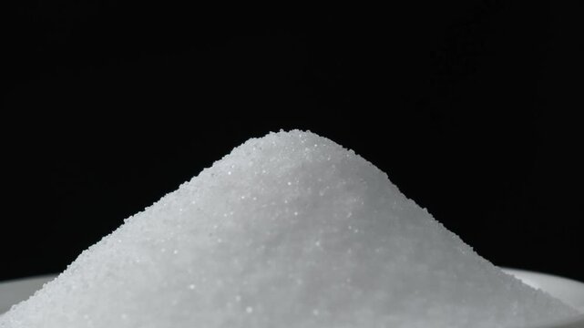 Pour sugar into a white bowl.