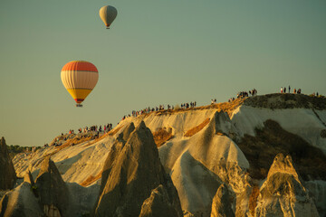 Mount with people watching hot air balloons in Cappadocia