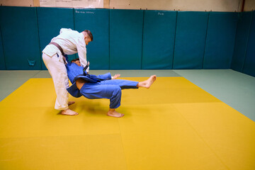 Martial arts training session indoors with two practitioners in action