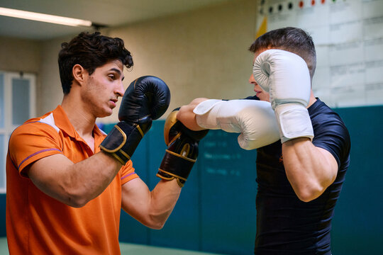 Boxing training session between two dedicated athletes in a gym