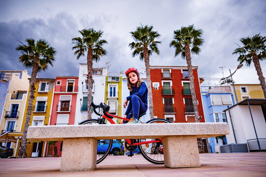 Boy with a bike on the beach promenade in Villajoyosa