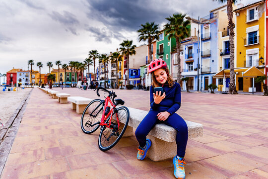 Child with mobile phone on the Villajoyosa beach promenade
