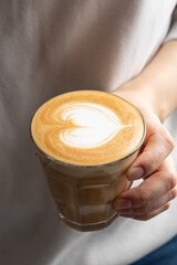 hand holding a cup of coffee