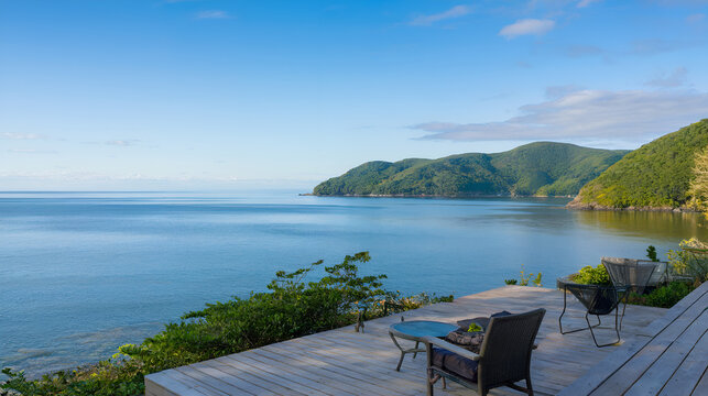Scenic coast landscape AI-generated, with views of green hills meeting the ocean. On a wooden deck, there are two chairs and a small table.