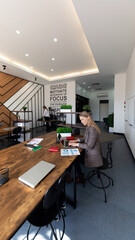 Modern workspace showcasing individuals engaged in collaborative activities and focused work in a bright office environment