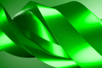 Abstract 3D render of a vibrant green ribbon with smooth curves and glossy texture. A futuristic design perfect for technology, environment, sustainability, and modern digital backgrounds.