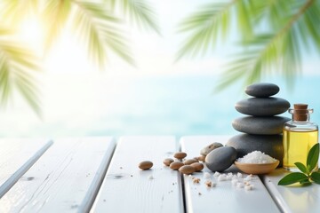 Obraz na płótnie Canvas Serene spa setting with stacked stones, essential oil bottle, and sea salt on a white wooden surface with tropical palm leaves and ocean view in the background