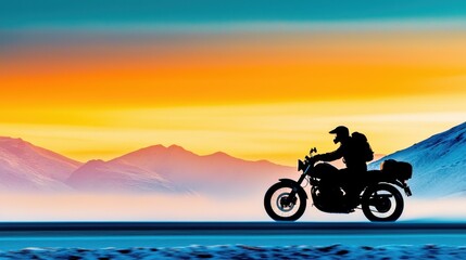 A silhouetted motorcyclist riding through a stunning sunset landscape.