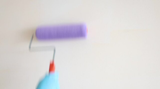 Paint roller on wall up and down