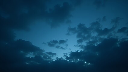 Fototapeta premium Dark blue stormy sky with thick, ominous clouds, dramatic weather, moody and atmospheric, natural scene, cloudy texture, low light
