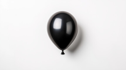 Obraz premium A single black balloon floating against a minimalistic white background. isolated on white background.