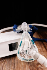 CPAP Therapy Device: White Machine with Display and Mask on Dark Wooden Table