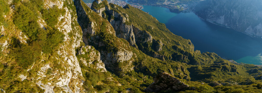Panoramic view of lakes and surrounding mountains near Belvedere del Parco Valentino at Piani Resinelli, Valsassina, Italy. Aerial view of province of Lecco, near Monte Coltignone and Cima Paradiso