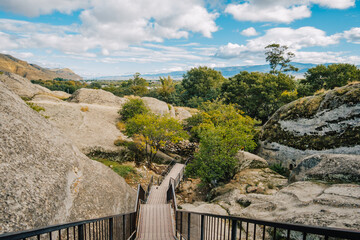 Stone stairway leading into Uplistsikhe’s ancient rock city — a pathway through history in...