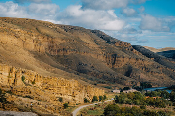 Panoramic view  the Koura River and the arid landscape from the cave dwelling of Uplistsikhe, Georgia — dramatic riverside rock city