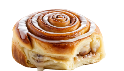 A close up shot of a cinnamon roll with white icing