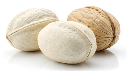 Obraz premium Walnuts Trio: A close-up captures a group of three walnuts, each showcasing the distinct textures and tones of their shells and kernels.