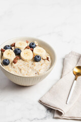 Oatmeal Bowl, Oat Porridge with berries, Banana and nuts in a Bowl, Healthy Snack or Breakfast