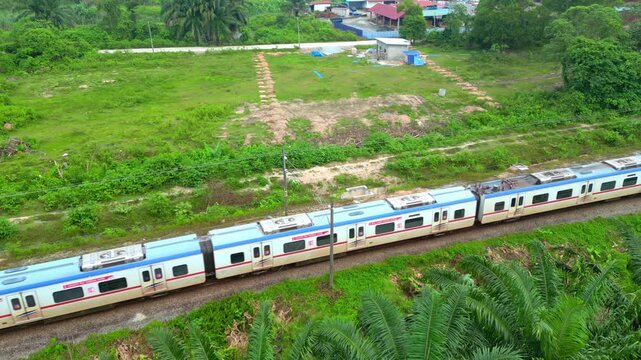 angi, Malaysia, December 21, 2024 High angle aerial view of KTM Train moving on railway track.