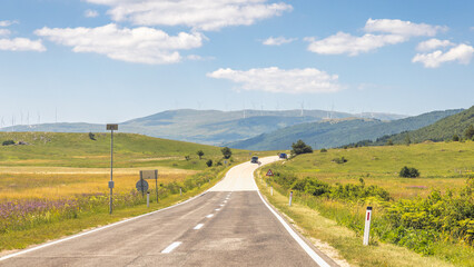 Road in Bosnia and Herzegovina, Europe. Scenic roadway through rolling hills leading to distant...