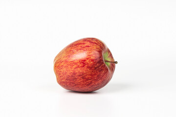 On a white background there is one beautiful ripe red apple. Isolated