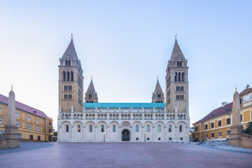 Obraz premium Cathedral in Pecs town in Hungary, Europe. Grand cathedral with twin towers and arched facade, bathed in soft morning light, reflects architectural grandeur and solemnity.