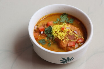kat vada or kat wada or vada usal, an authentic dish made with deep-fried potato dumplings and spicy gravy, street food, Indian food