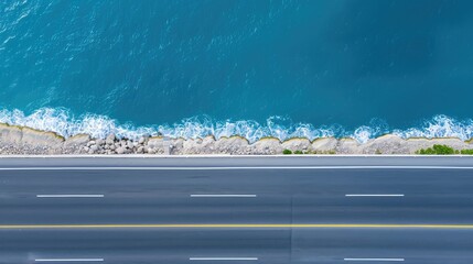 Aerial view showing coastline road beside vast blue ocean