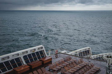 Views onto wet outdoor teak balcony terrace veranda promenade boat deck of ocean liner cruiseship...