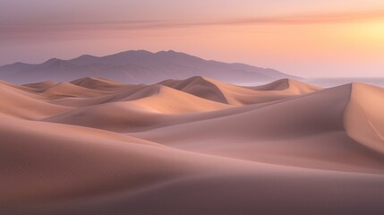 Serene desert landscape at sunrise, showcasing rolling sand dunes and distant mountains under a soft, pastel sky.