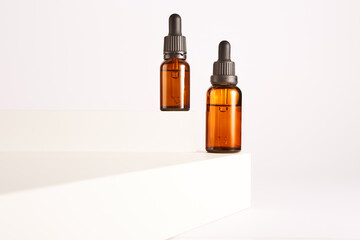 Dropper containers with pipettes on white background.