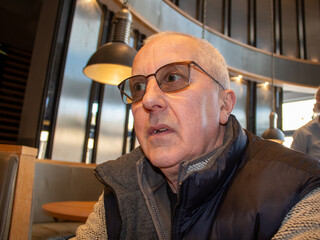 portrait of old man with glasses and a surprised face