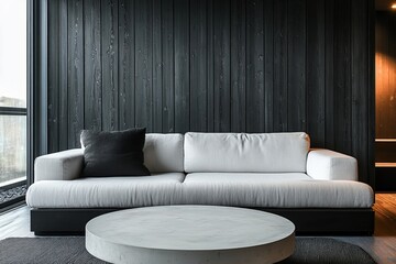 a modern living room with a white couch and dark wooden wall, a coffee table