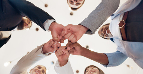 Business, people and support with fist bump in office for corporate collaboration, target success or finance goals. Below, employees and hands together for funding approval and investment celebration