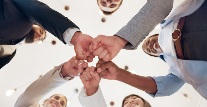 Business, people and support with fist bump in office for corporate collaboration, target success or finance goals. Below, employees and hands together for funding approval and investment celebration - Powered by Adobe