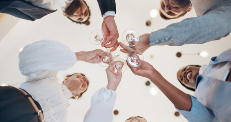 Office, toast and business people for celebration, success and social event in company party and low angle. Champagne glasses, alcohol and happy colleagues with team or cheers for work goals together