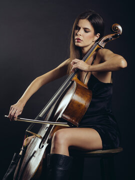 Attractive cello player playing her instrument