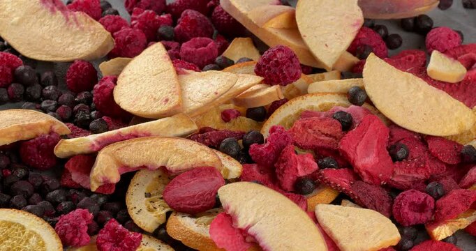 Freeze-dried fruits peaches, oranges, raspberries, strawberries, blackberries. Close-up footage on the rotating table.