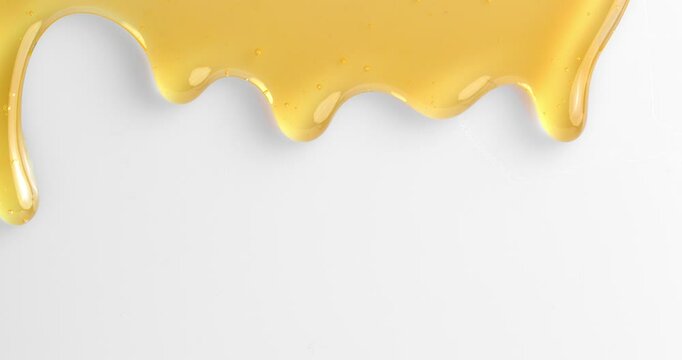 Honey dripping, pouring, flowing over white background. Healthy organic honey dipping.